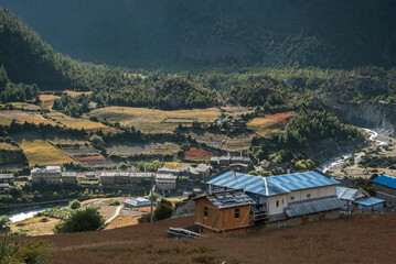 Naklejka premium Lower and Upper Pisang villages with Marshyangdi river in between, separating them, Around Annapurna trek, Manang village, Gandaki district, Nepal Himalayas, Nepal