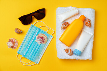 Sunscreen cream and protective mask. Coronavirus summer concept