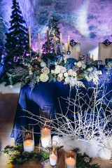 Flower decoration of wedding tables.
Banquet table setting and decoration. Cutlery on the table. Blue interior decoration. New Year's decoration.