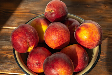 ripe peaches in an iron bowl/ close-up