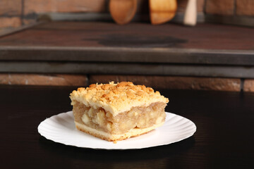 Apple Pie on disposable paper plate. Double crust apple pie with cinnamon made with shortcrust pastry.