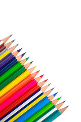 Angle line of different colored wood pencil crayons placed on a white background