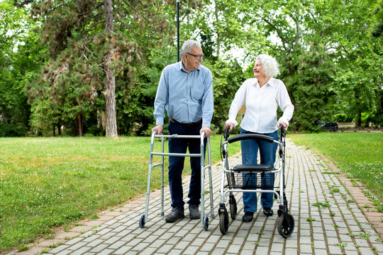 Elderly couple chatting and strolling in the park
