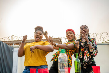 african girls dancing at an outdoor party, having fun