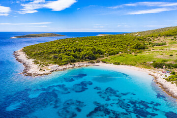 Fototapeta premium View of beautiful bay with blue turqoiuse sea on Mediterranean coast. Sailing destination. Summer vacation nackground with copy space. Vis island, Milna bay, Zaglav sandy beach. Seascape, cloudy sky
