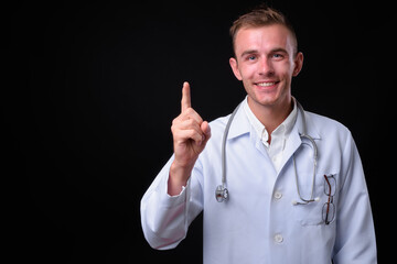 Portrait of young handsome man doctor with blond hair