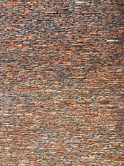 Large vertical brick wall faced with fine slate stone. Copy space text design background