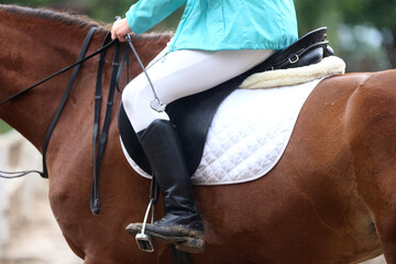 Photo of old leather saddle with stirrups