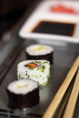 Sushi hosomaki and california maki on metal tray