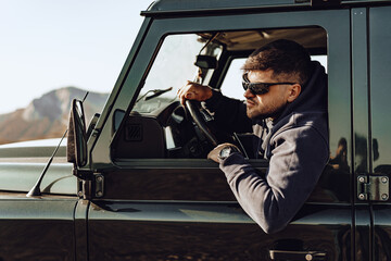 Male driver of an off-road car looking through the window © fotofabrika