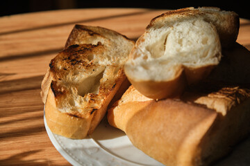 Roasted bread slices on wooden table