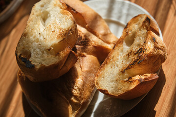 Roasted bread slices on wooden table