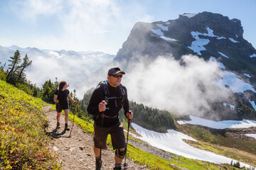 Adventurous Girl and Man Hiking in the Canadian Mountains during a sunny summer morning. Taken on the Trail to Cheam Peak in Chilliwack, East of Vancouver, British Columbia, Canada.