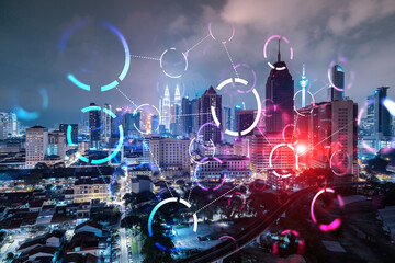 Naklejka premium Abstract technology icons, night aerial panoramic cityscape of Kuala Lumpur, Malaysia, Asia. The concept of innovative approach to optimize international business process. Double exposure.