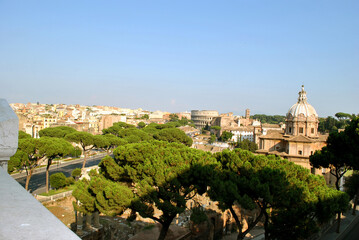 Fototapeta na wymiar Panoramic view on Rome city complete with the Roman forum the church Chiesa dei Santi Luca e Martina and the Colosseum from the Vittorio Emanuele II Monument also known as the Vittoriano.