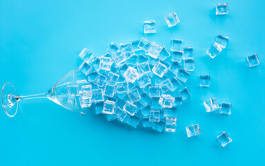 Ice cube with glass on blue background.cold drink or refreshing