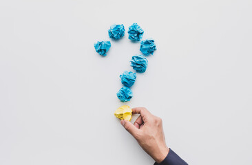 Question and answer or thinking ideas concepts with male hand holding paper crumpled ball