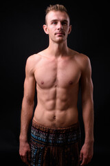 Portrait of young handsome shirtless man with blond hair