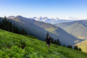 Obraz premium Adventurous Girl and Man Hiking in the Canadian Mountains during a sunny summer morning. Taken on the Trail to Cheam Peak in Chilliwack, East of Vancouver, British Columbia, Canada.