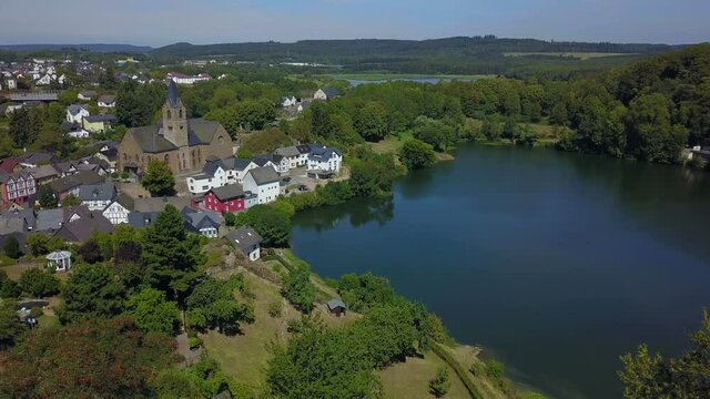 Ulmen (Ulmener) Maar with Parish Church of St. Matthew, Ulmen, Eifel, Rhineland-Palatinate, Germany