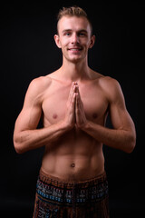 Obraz premium Portrait of young handsome shirtless man with blond hair