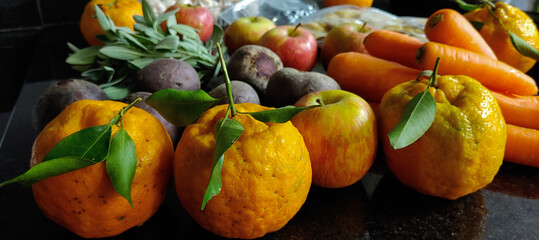 A small variety of fruits and vegetables that have just arrived from the organic fair.