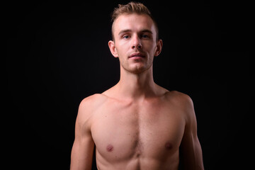 Fototapeta premium Portrait of young handsome shirtless man with blond hair