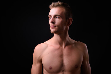 Fototapeta premium Portrait of young handsome shirtless man with blond hair