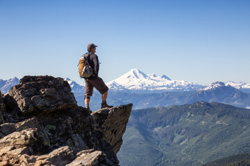 Adventurous Person Hiking in the Canadian Mountains during a sunny summer morning. Taken on the Trail to Cheam Peak in Chilliwack, East of Vancouver, British Columbia, Canada.