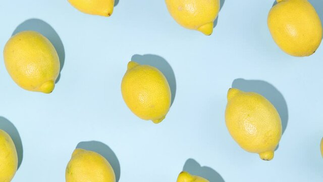 Lemon moves on the blue background - Stop motion animation - Seamless pattern with lemons