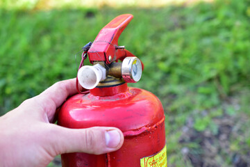 Naklejka premium Red balloon hand extinguisher in the garden