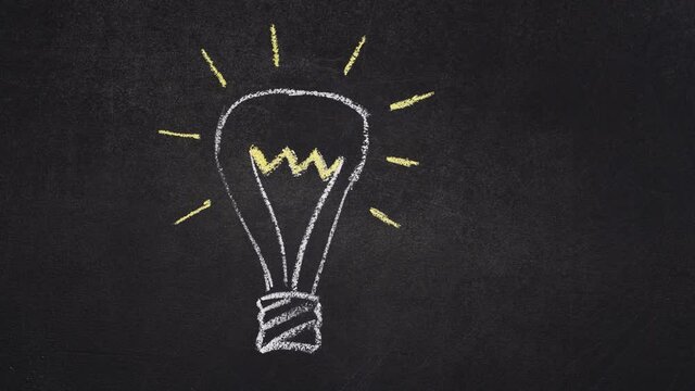 Stop motion shining light bulb symbolizing idea being drawn with lines on black chalkboard