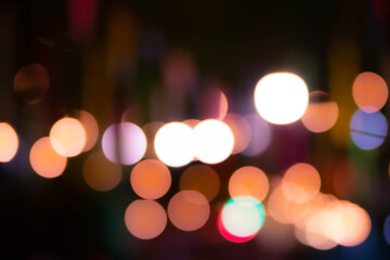 Blur the lights on the restaurant. Blurred cafe background with bokeh. orange ,red, light, blue, green, pink.
