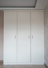 white wardrobe with unusual door handles