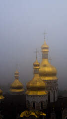 Kiev, Ukraine - Foggy view of golden domes in an ancient Ukrainian monastery. Concept photo with a religious theme.

