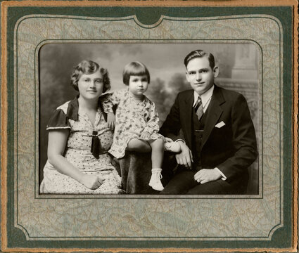 Vintage 20th century family portrait with mom, dad and daughter