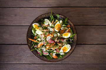 Smocked mackerel fish salad with eggs, arugula and vegetables. Overhead horizontal photo