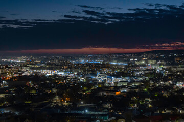 Multi-colored (blue and orange colors) sunset on the city of Saratov. View from the observation deck to the night city.