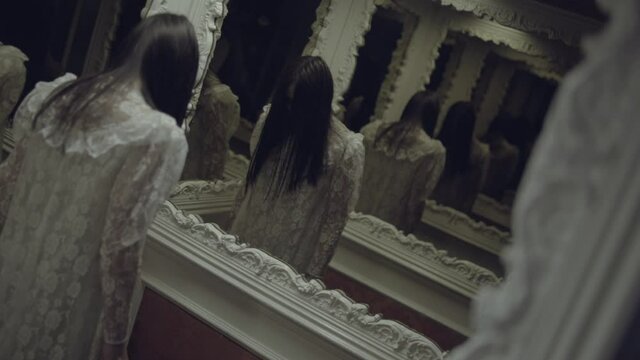 Scary brunette lady standing in front of mirror, mysterious phantom of bride