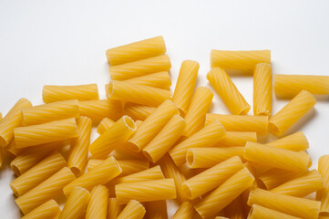 tortiglioni macaroni Italian dry raw pasta bronze drawn white background top view