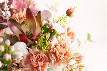 Autumn composition made of beautiful flowers on light backdrop. Floristic decoration. Natural...