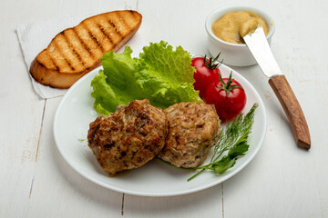 meatballs with tomatoes and lettuce, toast and mustard  on white background