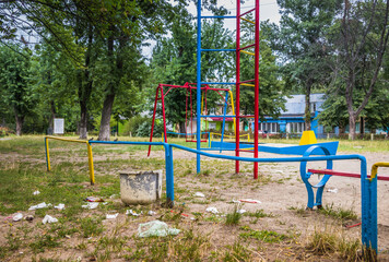 Garbage is on a children's Playground .Garbage around the rubbish bin