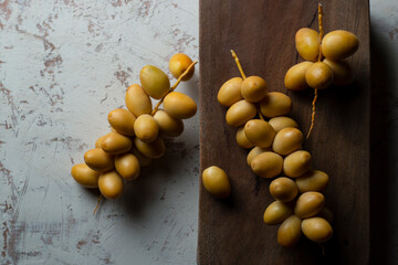 fresh dates fruit on wooden background , red and yellow fresh date fruits 