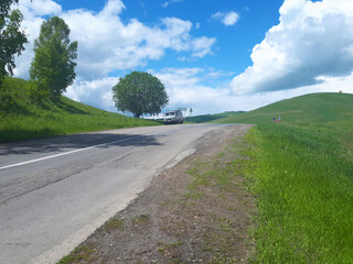 Landscape. Pass in the Altai mountains. UAZ camper against the blue sky.