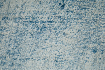 Blue background rustic texture of damage wall. Vintage abstract field of erased paint. Cracks from plaster. Old dark side of antique house. Image with copy space.
