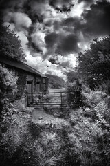 infrared landscape in black and white with building cornwall uk 
