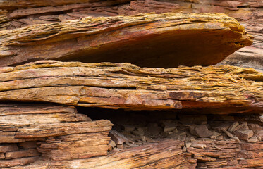 Layered brown-red crumbling rock, close-up