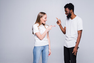 Happy multiracial young couple laugh with white toothy smile at funny joke together. Excited...