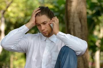 Handsome bearded businessman with long hair at the park